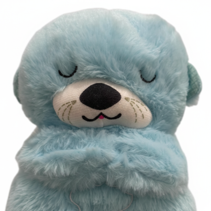 Gros plan sur la texture pelucheuse et les petits bras du doudou loutre bleu turquoise