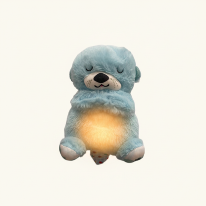 Doudou loutre bleu turquoise avec une douce lueur ambrée au ventre